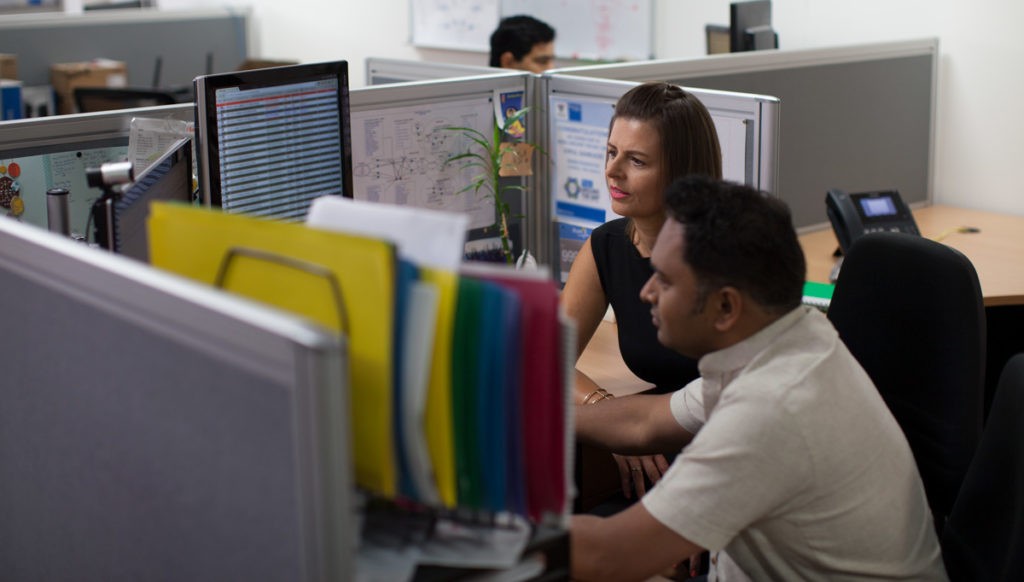 Two colleagues working on a computer