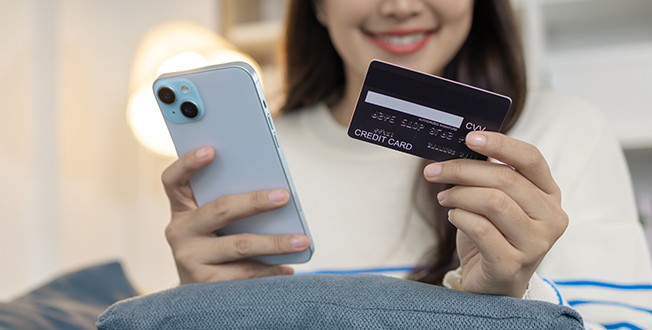 A person using a mobile phone to make a banking transaction